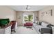 Cozy living room featuring neutral tones, a ceiling fan, and views of the outdoor waterway at 1355 Rock Dove Ct # 1-2, Punta Gorda, FL 33950