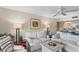Inviting living room with white sofas, a neutral color scheme, and seamless flow to the kitchen area at 1355 Rock Dove Ct # 1-2, Punta Gorda, FL 33950