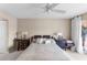 Comfortable bedroom with neutral tones, ceiling fan, and a sliding door to the balcony at 1355 Rock Dove Ct # 1-2, Punta Gorda, FL 33950