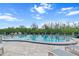 Community pool area with inviting lounge chairs surrounded by landscaping and fencing at 1355 Rock Dove Ct # 1-2, Punta Gorda, FL 33950