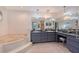 Large bathroom with dual sinks, soaking tub, and a vanity area providing a spa-like experience at 1626 Ridgewood Ln, Sarasota, FL 34231