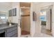 Bathroom featuring a walk-in shower, vanity with granite countertop and modern fixtures at 1626 Ridgewood Ln, Sarasota, FL 34231