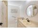 Bright bathroom featuring a round mirror, tile flooring, and a shower with white shower curtain at 1626 Ridgewood Ln, Sarasota, FL 34231