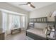 Cozy bedroom features a bunk bed, bench by the bay window, and stylish ceiling fan at 1626 Ridgewood Ln, Sarasota, FL 34231