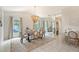 Elegant dining room with a striking chandelier, ample natural light, and a mirrored wall, perfect for entertaining guests at 1626 Ridgewood Ln, Sarasota, FL 34231