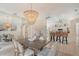 Open-concept dining room with a modern chandelier, comfortable seating, and a seamless transition to the kitchen area at 1626 Ridgewood Ln, Sarasota, FL 34231