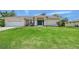 Charming single-story home featuring a well-manicured lawn and tasteful landscaping, plus an attached two-car garage at 1626 Ridgewood Ln, Sarasota, FL 34231