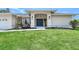Inviting home featuring a lush green lawn, decorative landscaping, and a stylish front entrance with a striking front door at 1626 Ridgewood Ln, Sarasota, FL 34231