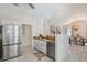 Open-concept kitchen with granite countertops and stainless steel appliances overlooks the dining area at 1626 Ridgewood Ln, Sarasota, FL 34231