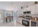 Bright kitchen and dining room combo with stainless appliances, wine storage and granite countertops at 1626 Ridgewood Ln, Sarasota, FL 34231