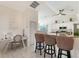 Bright kitchen features an island with bar seating, white cabinets and modern appliances, plus a built in desk at 1626 Ridgewood Ln, Sarasota, FL 34231
