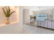 Bright living room with tile flooring, a decorative alcove, and views of the screened pool area at 1626 Ridgewood Ln, Sarasota, FL 34231