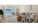 Bright living area featuring a striped sofa, stylish furnishings, and sliding glass doors that lead to a pool area at 1626 Ridgewood Ln, Sarasota, FL 34231