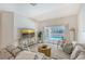 Comfortable living room featuring a plush sofa, stylish decor, and sliding glass doors that offer views of the pool at 1626 Ridgewood Ln, Sarasota, FL 34231