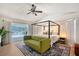 Spacious main bedroom with a sitting area and a sliding door leading to the screened-in lanai at 1626 Ridgewood Ln, Sarasota, FL 34231