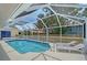 Sparkling pool with screened enclosure, lounge chairs, and well-maintained backyard at 1626 Ridgewood Ln, Sarasota, FL 34231