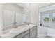 Bathroom featuring double sinks with granite counters, plenty of space, and neutral colors at 17536 Cantarina Cv, Bradenton, FL 34211
