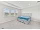 Well-lit bedroom featuring plush carpeting, bed, and windows at 17536 Cantarina Cv, Bradenton, FL 34211