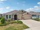 Charming home featuring a 3-car garage, well-manicured landscaping, and a neatly kept lawn at 17536 Cantarina Cv, Bradenton, FL 34211