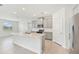 Modern kitchen featuring a large island, stainless steel appliances, and ample cabinet space at 17536 Cantarina Cv, Bradenton, FL 34211