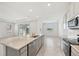 Bright, open kitchen features stainless appliances, granite counters, and tile floors at 17536 Cantarina Cv, Bradenton, FL 34211