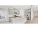 Well-equipped kitchen with island, stainless steel appliances, modern cabinetry, and tile backsplash at 17536 Cantarina Cv, Bradenton, FL 34211
