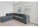 Bright living room featuring a comfortable sectional sofa with ottoman and large window at 17536 Cantarina Cv, Bradenton, FL 34211