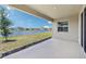 Covered patio overlooking a picturesque pond and neighboring houses at 17536 Cantarina Cv, Bradenton, FL 34211