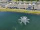 A gorgeous pond with a fountain and lush landscaping enhances the community at 17536 Cantarina Cv, Bradenton, FL 34211