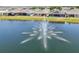 Tranquil pond with fountain surrounded by homes in a peaceful community at 17536 Cantarina Cv, Bradenton, FL 34211