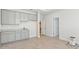 Open room with cabinets, sink, light counter, and multiple doorways at 17536 Cantarina Cv, Bradenton, FL 34211