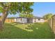 Expansive backyard featuring a lush green lawn, privacy fence, and mature trees at 1801 W Saint Isabel St, Tampa, FL 33607