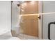 Contemporary shower with sleek glass enclosure and wood paneling with LED lighting at 1801 W Saint Isabel St, Tampa, FL 33607