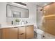 Modern bathroom featuring double vanity, stylish mirror, and glass enclosed shower with wood accents at 1801 W Saint Isabel St, Tampa, FL 33607