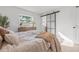 Bedroom featuring a window and a stylish sliding barn door, offering natural light and unique charm at 1801 W Saint Isabel St, Tampa, FL 33607