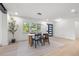 Dining room featuring a modern table and chairs, a linear light fixture, and a view outside at 1801 W Saint Isabel St, Tampa, FL 33607