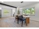 Bright dining room with wood table, black chairs, modern light fixture, and a large window at 1801 W Saint Isabel St, Tampa, FL 33607