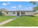 Charming single-story home with modern appeal, showcasing a well-manicured lawn and updated exterior at 1801 W Saint Isabel St, Tampa, FL 33607
