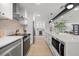 Modern kitchen with stainless steel appliances, island with seating and views into adjacent living spaces at 1801 W Saint Isabel St, Tampa, FL 33607