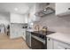 Bright kitchen with stainless steel appliances, quartz countertops, modern cabinetry, and sleek black hardware at 1801 W Saint Isabel St, Tampa, FL 33607