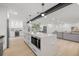Spacious open floor plan with modern kitchen island, stainless appliances and view of living space at 1801 W Saint Isabel St, Tampa, FL 33607