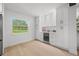 Bright kitchen featuring white cabinets, sleek countertops, and a beverage refrigerator at 1801 W Saint Isabel St, Tampa, FL 33607