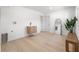 Bright laundry room featuring light wood floors, modern cabinet, and utility sink at 1801 W Saint Isabel St, Tampa, FL 33607