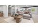 Open-concept living room with a modern sectional sofa, stylish decor, and a barn door feature at 1801 W Saint Isabel St, Tampa, FL 33607