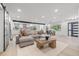 Bright living area with modern furniture, decor, and an open view of the kitchen and dining room at 1801 W Saint Isabel St, Tampa, FL 33607