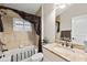 This bathroom features a granite countertop, framed mirror, and a tile shower/tub with a decorative drape at 2152 Majestic Oaks Blvd, Clearwater, FL 33759