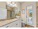 This bathroom features a granite countertop, framed mirror, a tiled glass shower, and a door to the exterior at 2152 Majestic Oaks Blvd, Clearwater, FL 33759