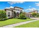 Charming home with lush landscaping, a stone facade, and a well-manicured lawn at 2152 Majestic Oaks Blvd, Clearwater, FL 33759