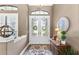 Inviting foyer with decorative double doors, a stylish rug, and elegant decor at 2152 Majestic Oaks Blvd, Clearwater, FL 33759