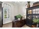 Well-lit home office with a large desk, built-in bookcase, and plantation shutters at 2152 Majestic Oaks Blvd, Clearwater, FL 33759